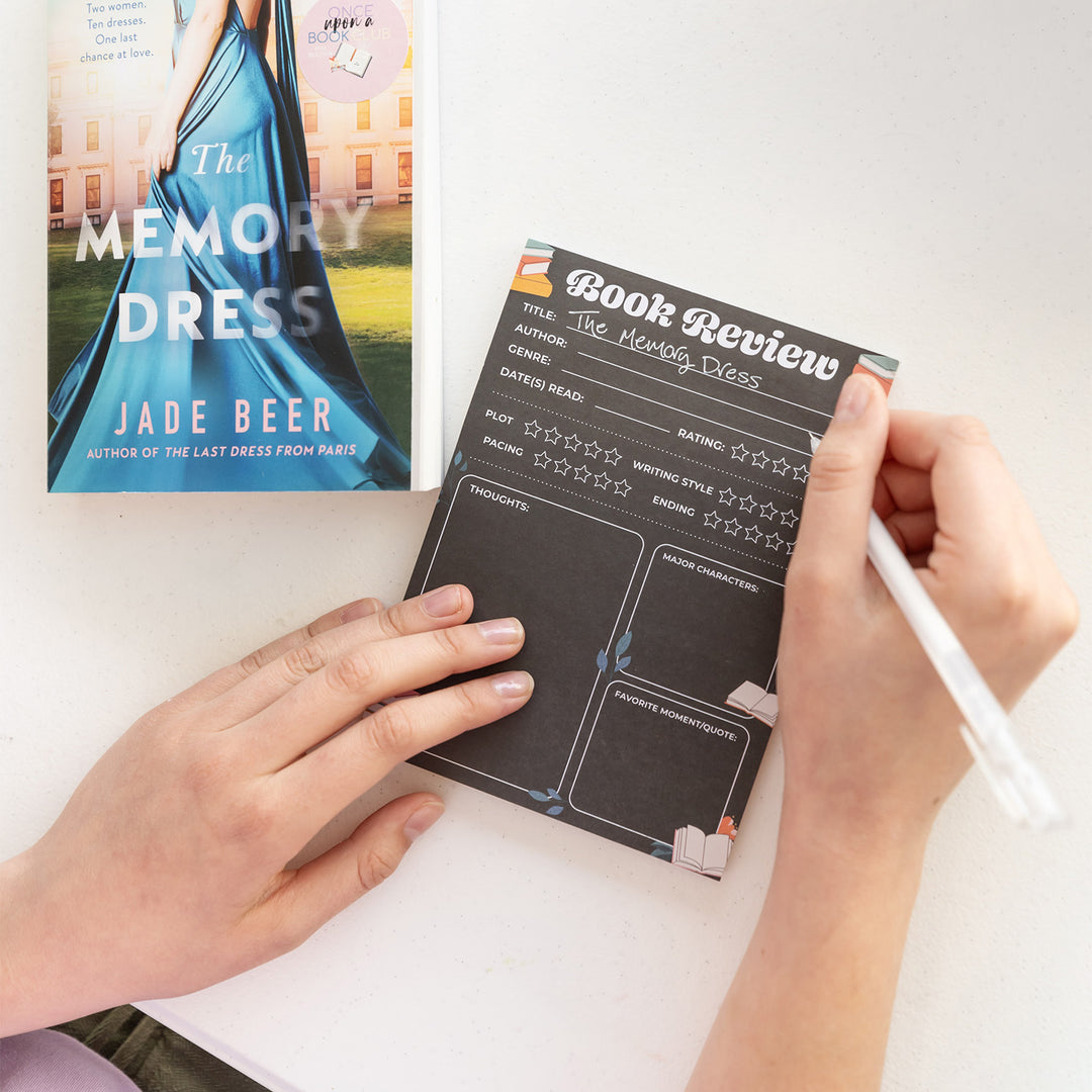 A black Book Review pad and white gel pen to write in your current reads and all the information about it!