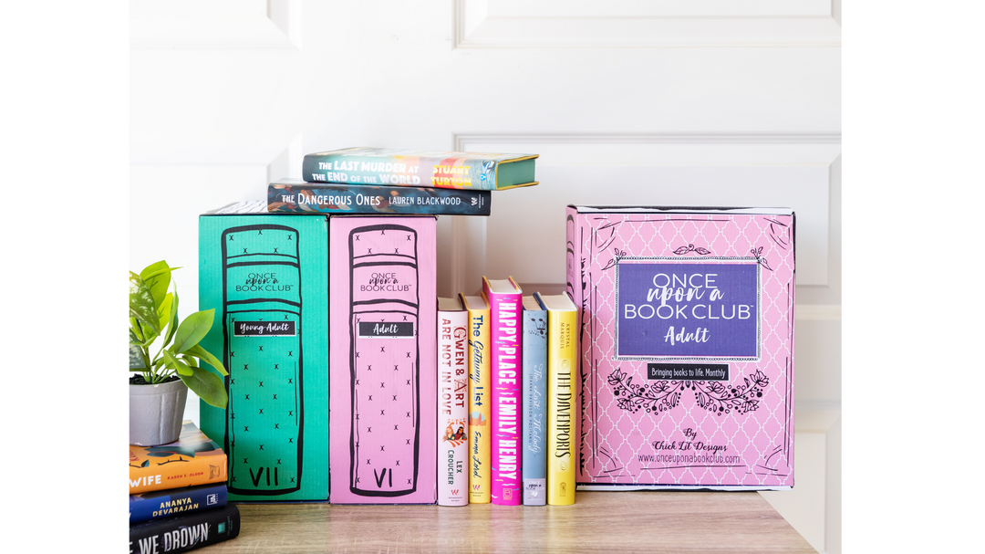 A cozy bookshelf display featuring Once Upon a Book Club subscription boxes, books, and decorative elements.