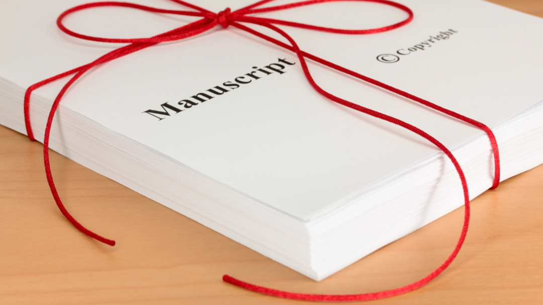 A manuscript tied with a red ribbon, ready to be submitted—symbolizing a debut author’s finished work.