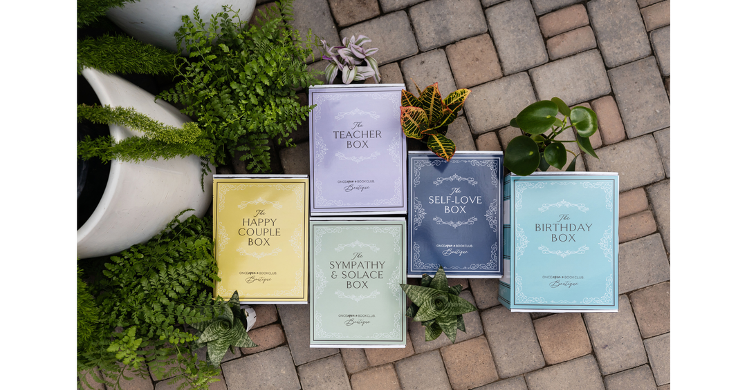 OUABC Care Packages in colorful book-shaped boxes for birthdays, couples, teachers, self-care, and more.