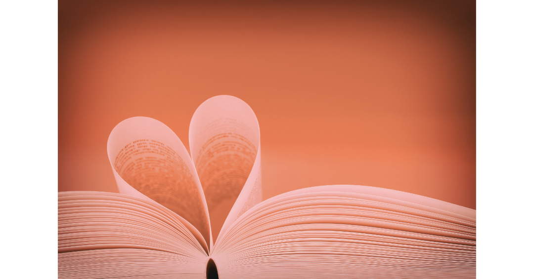 Open book with pages folded into a heart shape, symbolizing romance novels and the love of reading.
