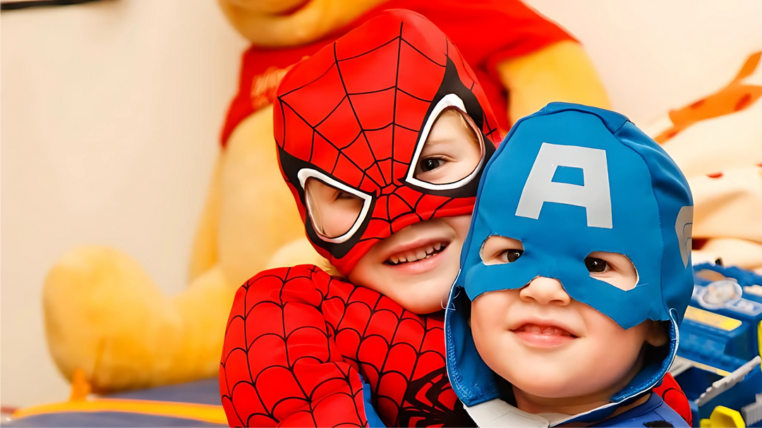 Two children dressed as superheroes, one in a Spider-Man costume and the other in a Captain America outfit, smiling happily.