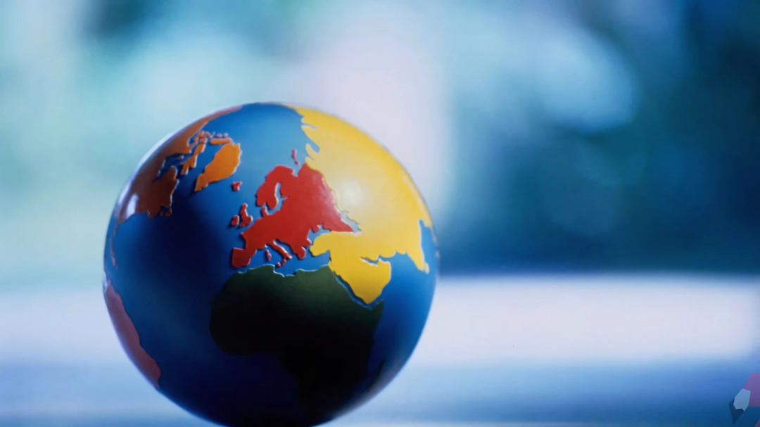 A colorful globe model against a soft, blurred background, symbolizing the transformative power of reading and its ability to connect and change the world.