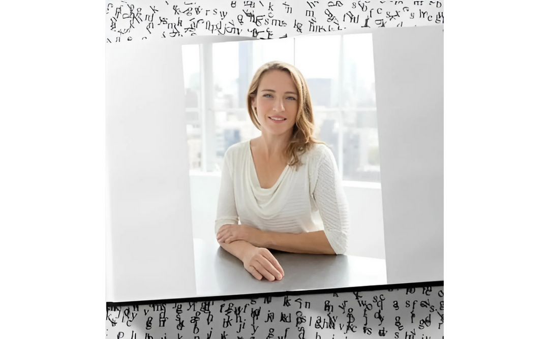 Wendy Walker, an author, seated at a table, wearing a white blouse, smiling gently, with a cityscape visible through large windows.