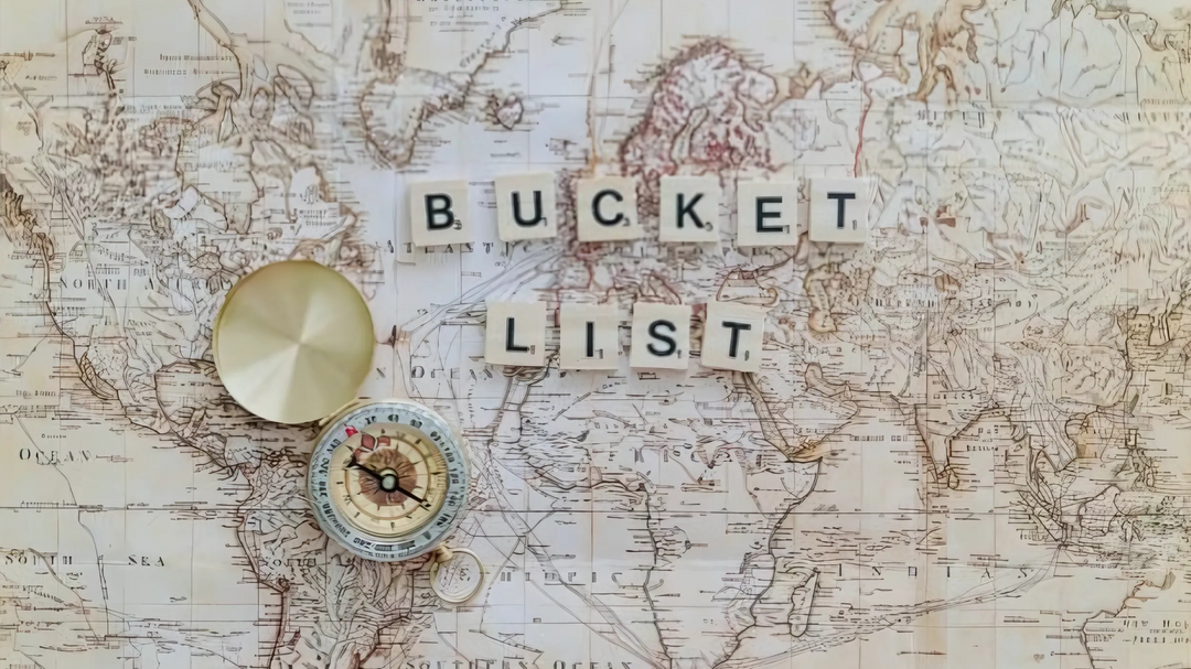 A vintage map background with a compass and Scrabble tiles spelling "Bucket List," evoking adventure, travel, and future goals.