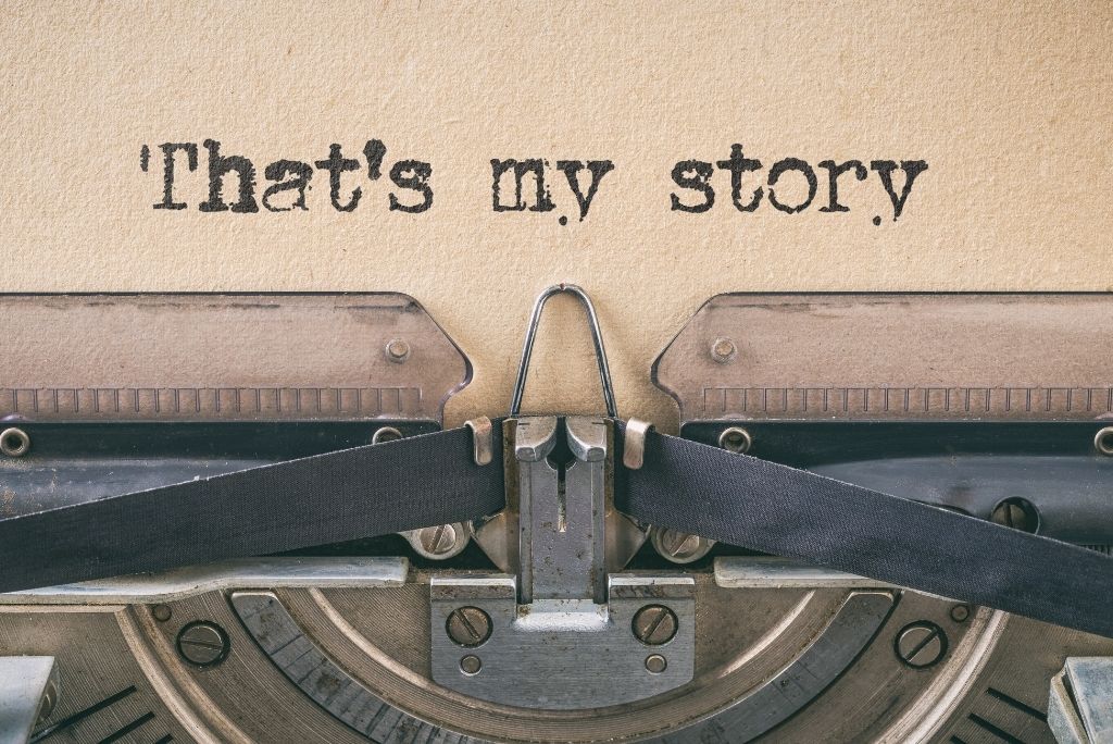 Vintage typewriter with a page reading "That's my story" suggesting the start of a personal narrative.
