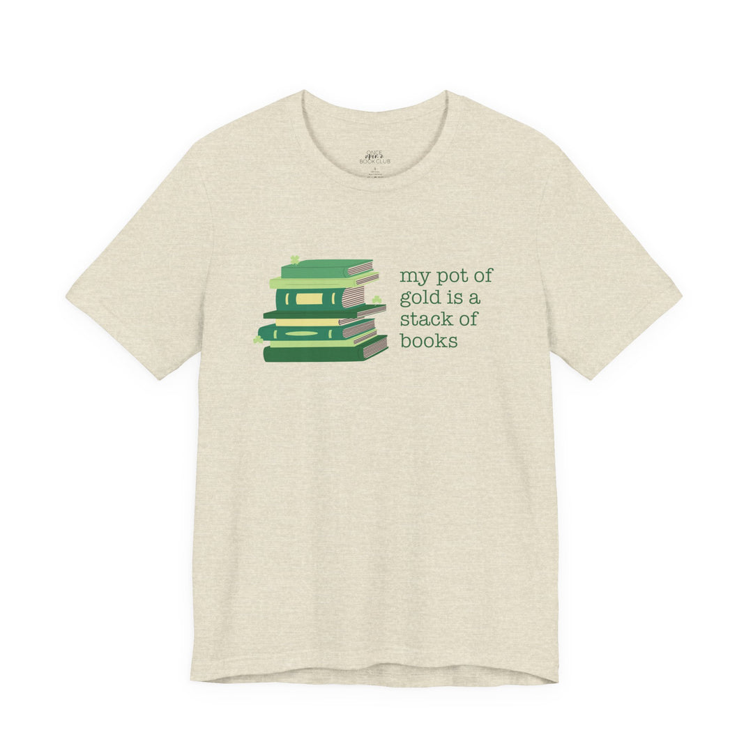 Beige t-shirt with green stack of books and clovers graphic and text "my pot of gold is a stack of books" on a white background