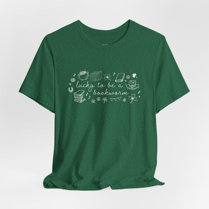 Green t-shirt with white font reading "lucky to be a bookworm" and line illustrations of St. Patrick's Day items and books on a white background