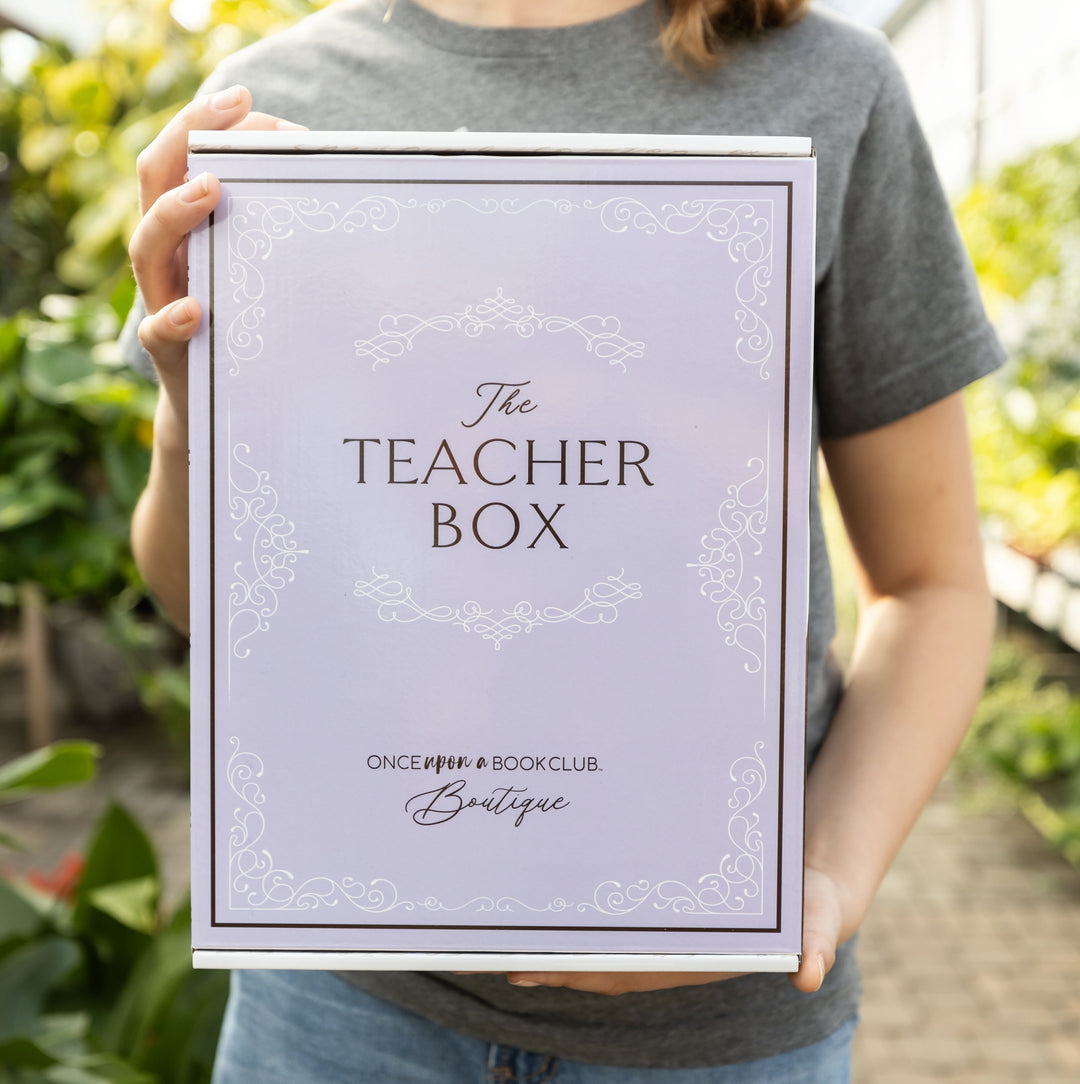 A girl holds the light purple Teacher box.