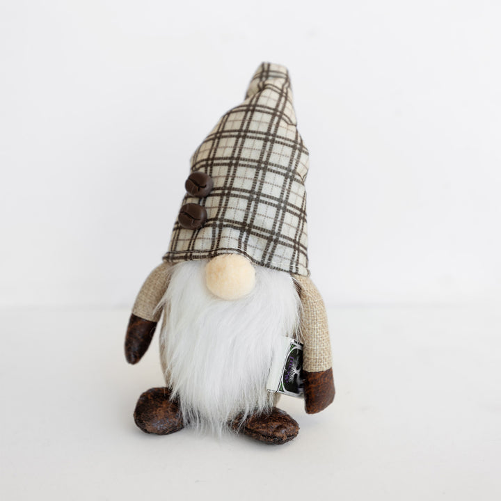 A small gnome plushie holding a copy of the OUABC special edition of Soul of Shadow