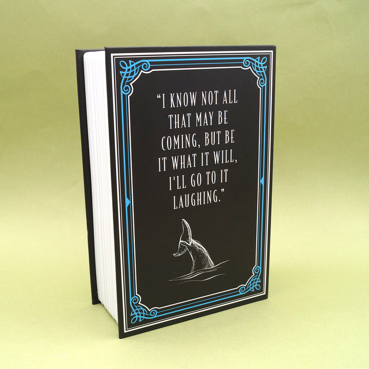 the back of the book safe featuring a whale tale above the waves and the quote "I know not all that may be coming, but be what it will, I'll go to it laughing."