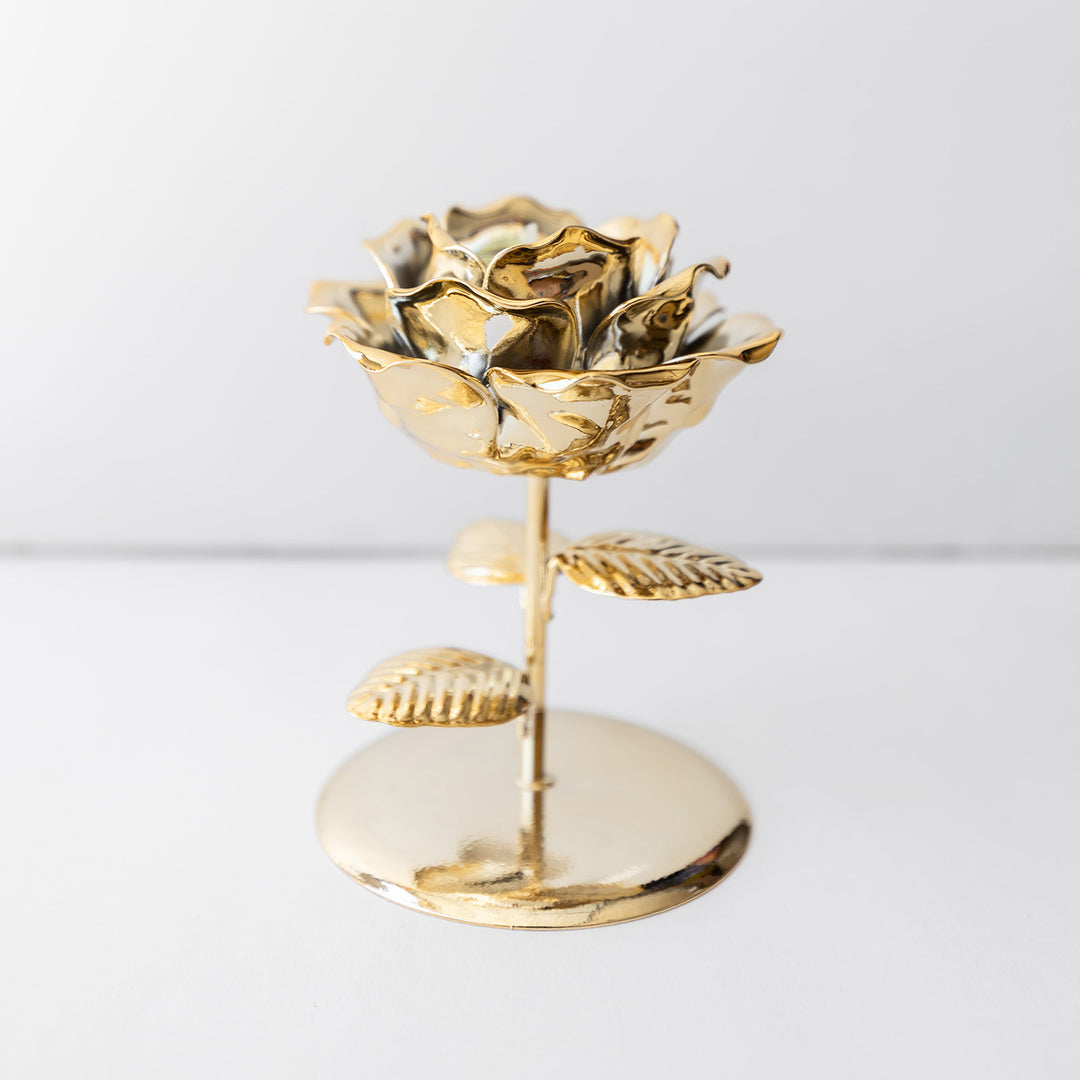 A gold flower-shaped candle holder