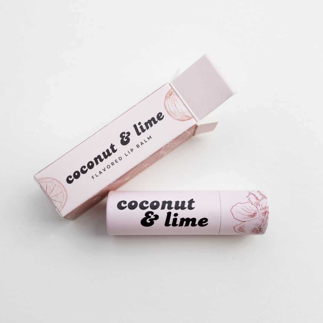 Coconut & Lime flavored lip balm with packaging on a light background