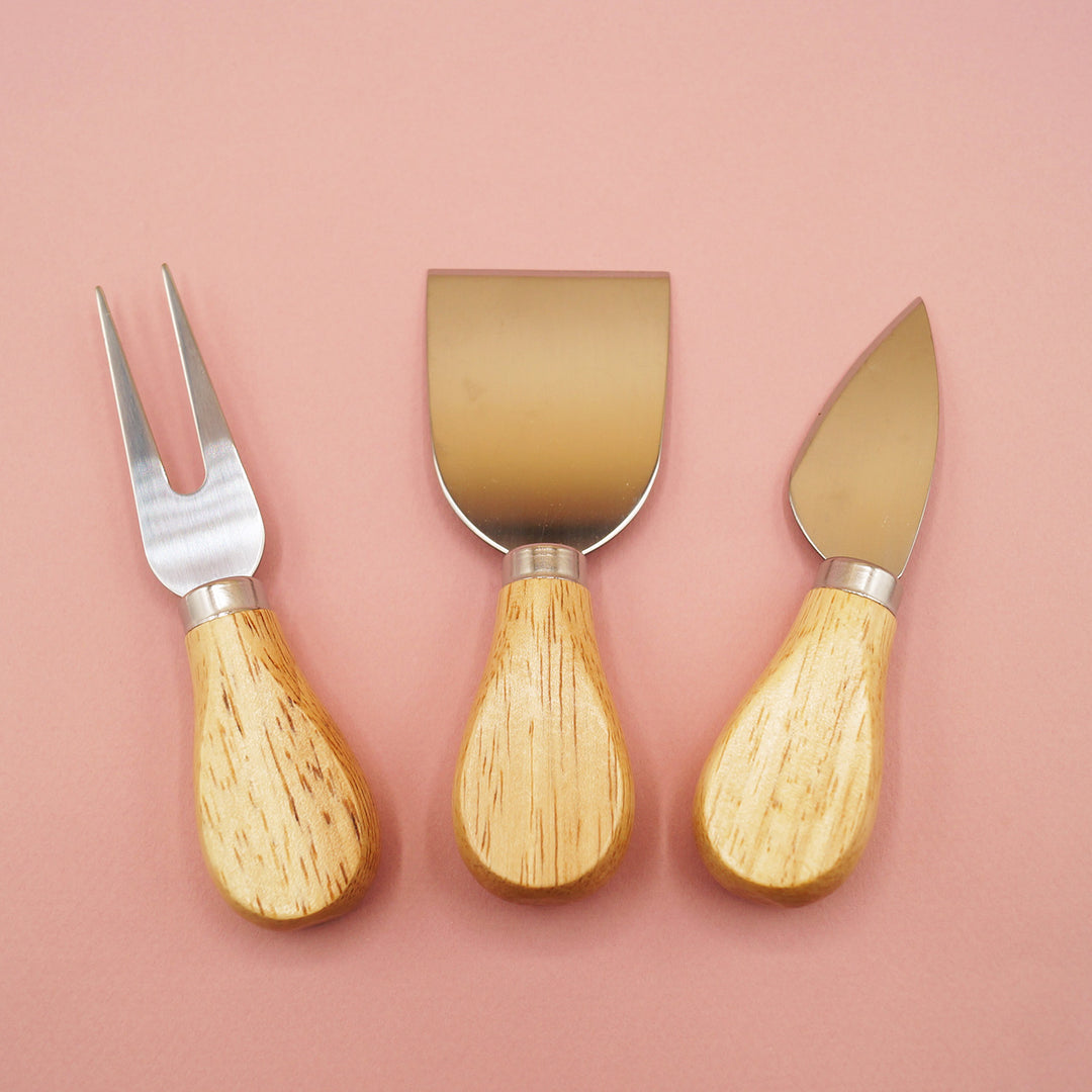 the three cheese knives included in the set including a cheese fork, a flat cheese knife and a spade cheese knife.