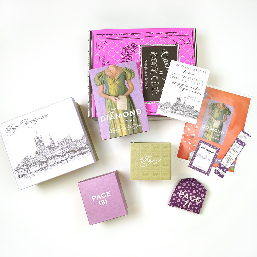 A pink box lays on a white background. On top of the box is a hardcover, exclusive edition of THE DIAMOND OF LONDON by Andrea Penrose. Around the book and box are four wrapped packages labeled with page numbers meant only to be opened as you read the included book and reach the specified pages. All packaging features regency-inspired designs. Also included is a quote print, bookmark, signed bookplate from the author, and a Book Club Kit with information about the book.