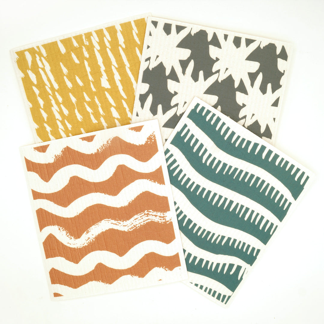 four square dish cloths with varying colors and patterns - one yellow and white, one orange and white, one teal and white, and one gray and white