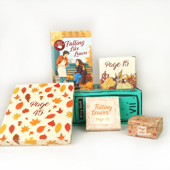 A copy of Falling Like Leaves by Misty Wilson is surrounded by wrapped gifts labeled with page numbers featuring an autumn theme on a light gray background