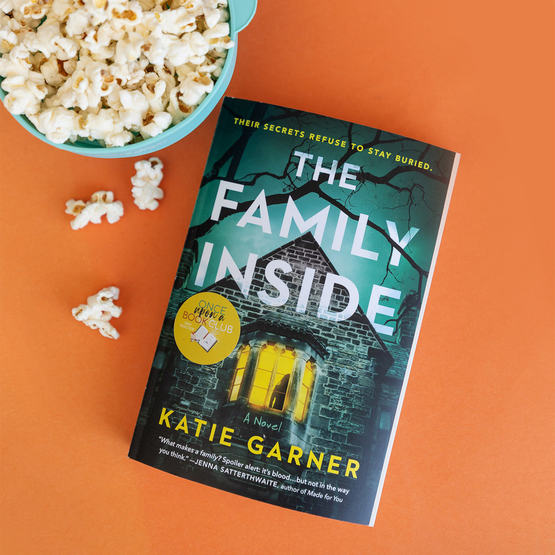 Book titled 'The Family Inside' by Katie Garner with popcorn on an orange background