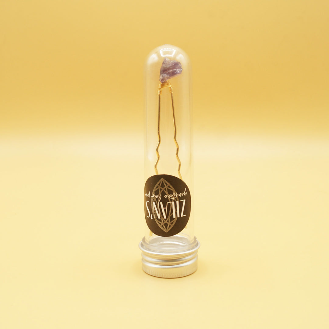 a small tube labeled "Zilan's gemstone hair pin" sits on a yellow background