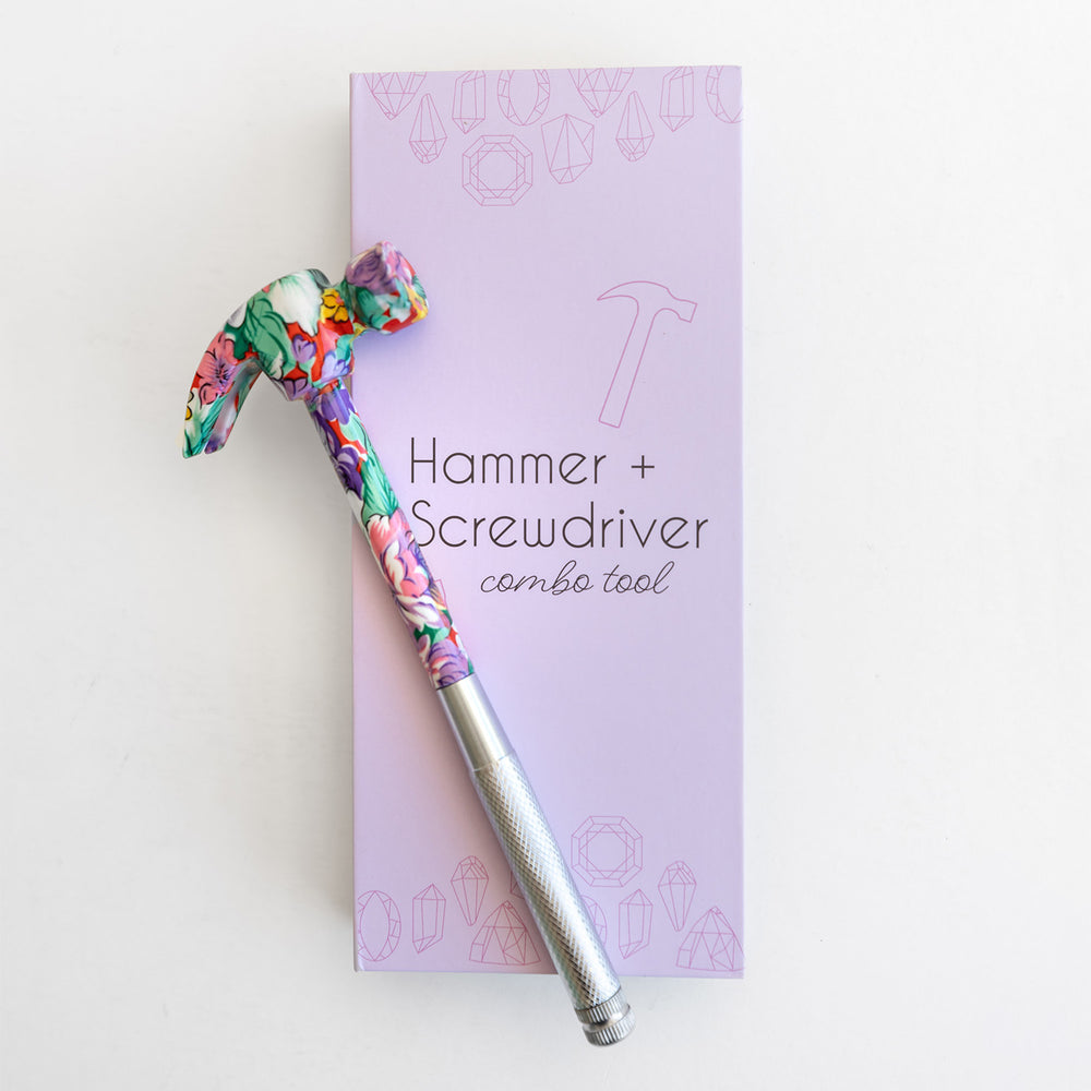 Floral-patterned hammer and screwdriver combo tool on a purple box with text