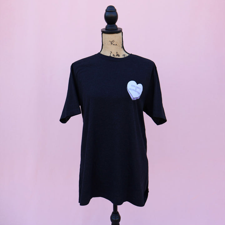 Black t-shirt with a purple heart-shaped candy design and 'Grumpy x Sunshine' text on a pink background.