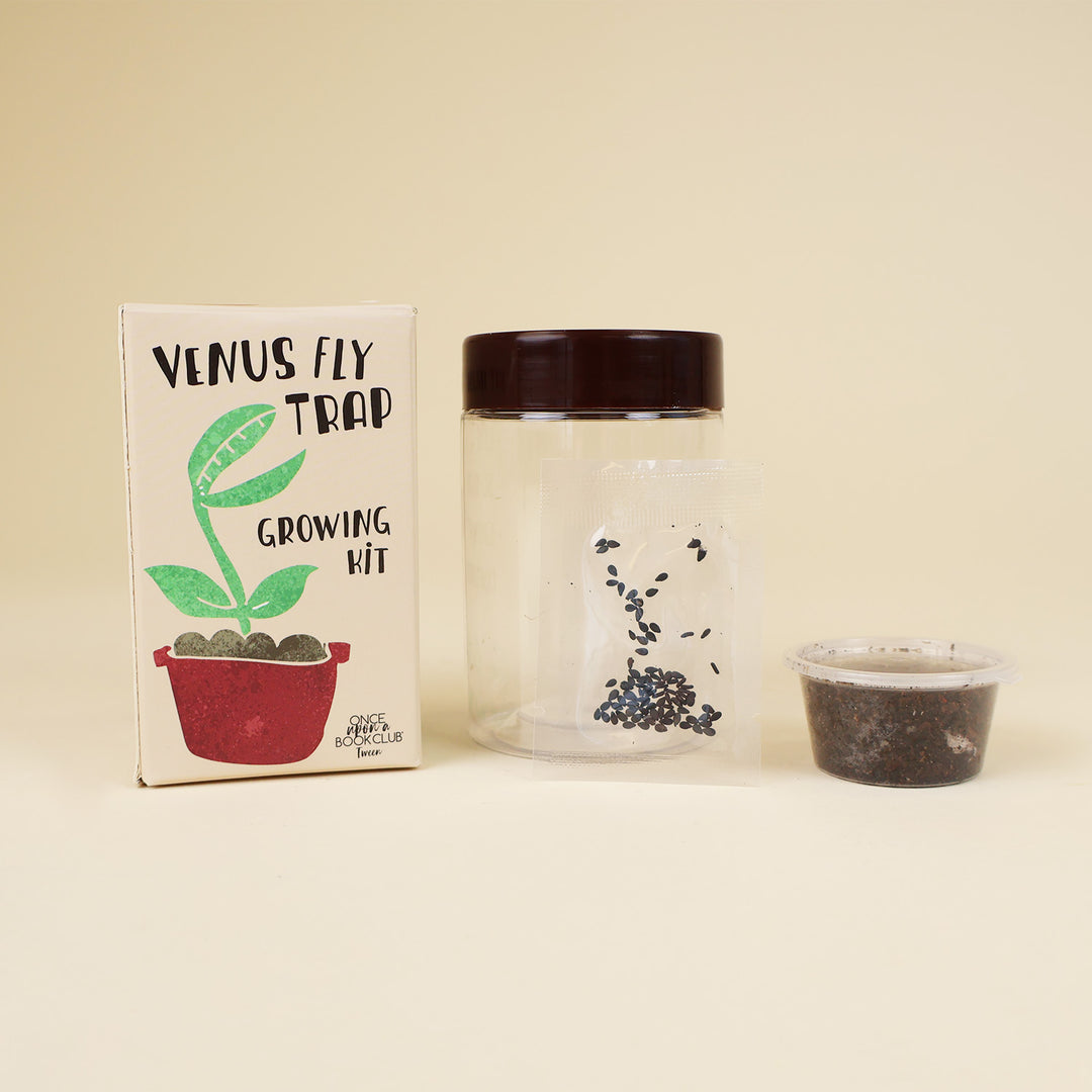 From left to right, a small box labeled Venus Fly Trap Growing Kit with a cartoon image of a venus fly trap, a clear jar with seeds in it, and a small container of dirt.