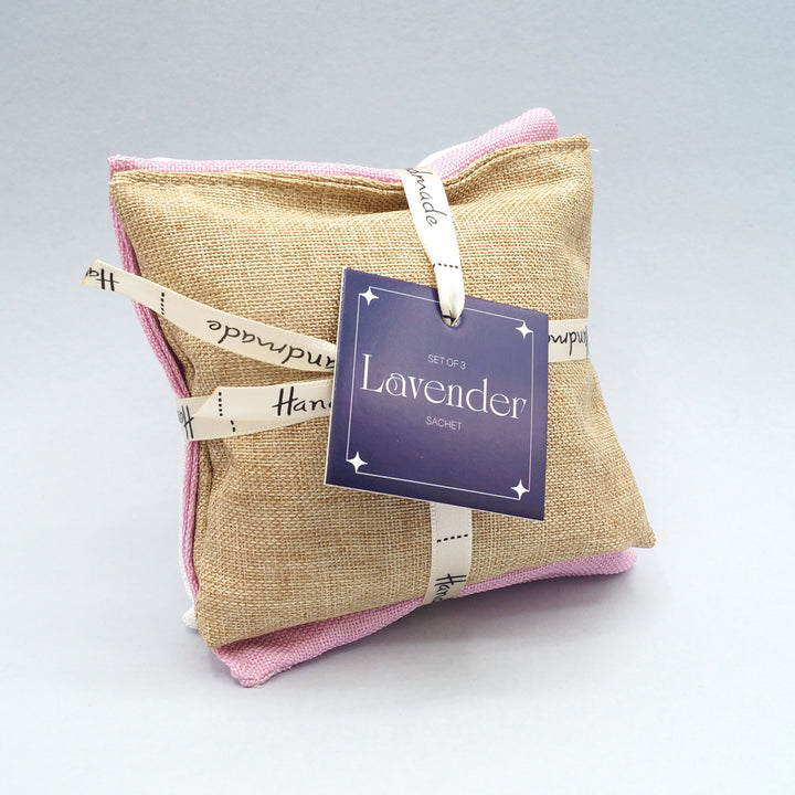 a stack of 3 lavender sachets in tan, pink, and white (one color each)