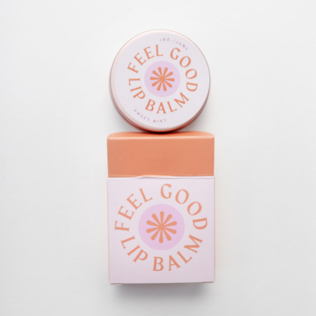 a circular container of Feel Good Lip Balm next to a small box