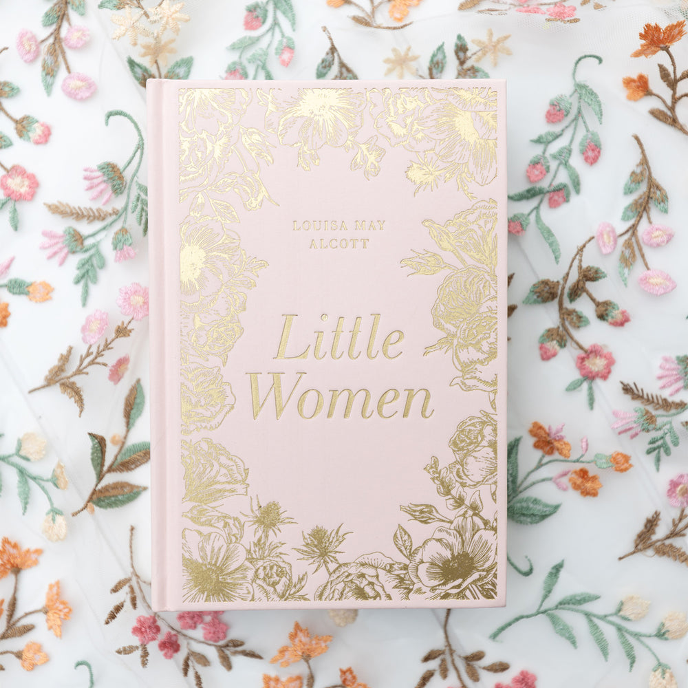 Book titled 'Little Women' with pink fabric and gold foiling on a floral background