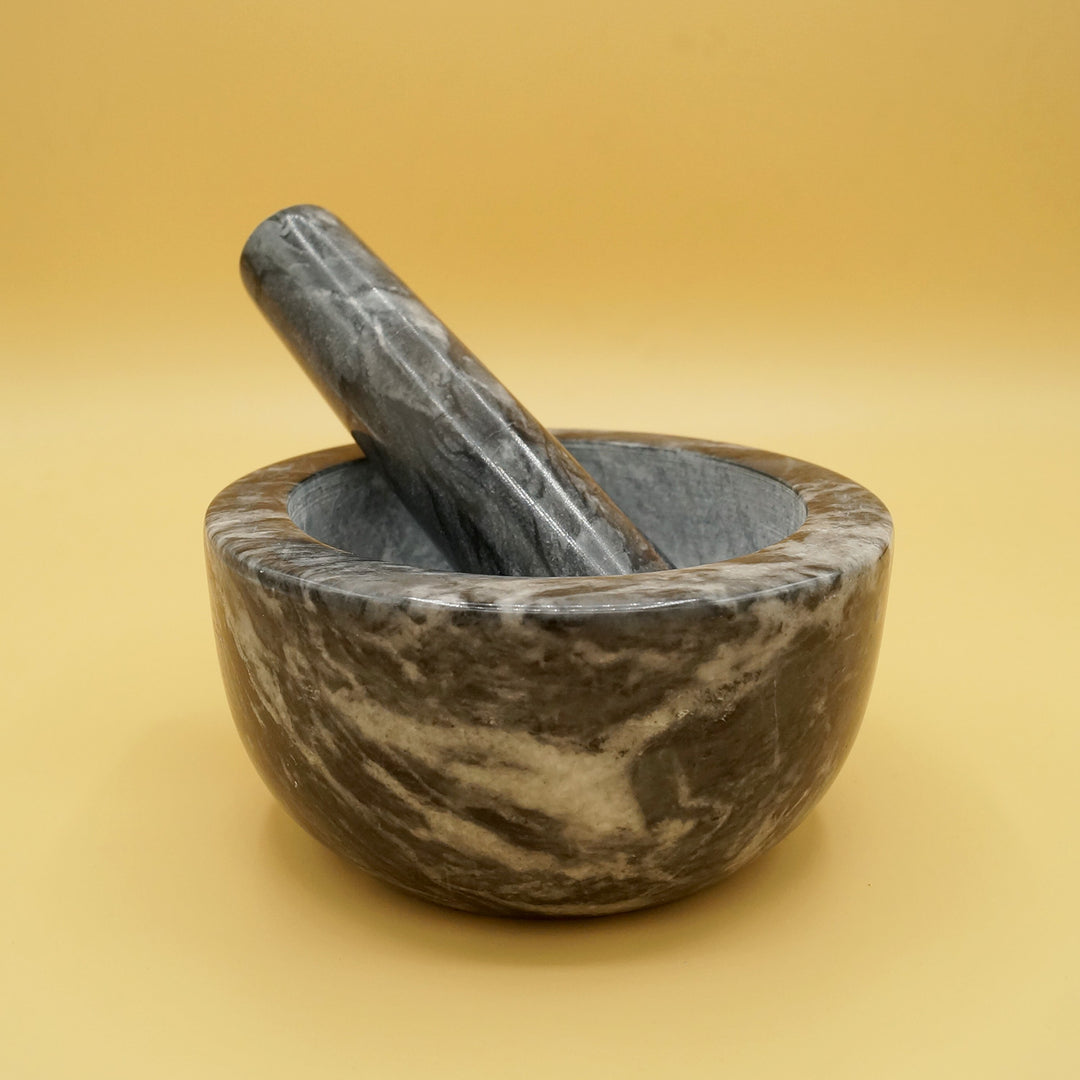 a black marble mortar and pestle 