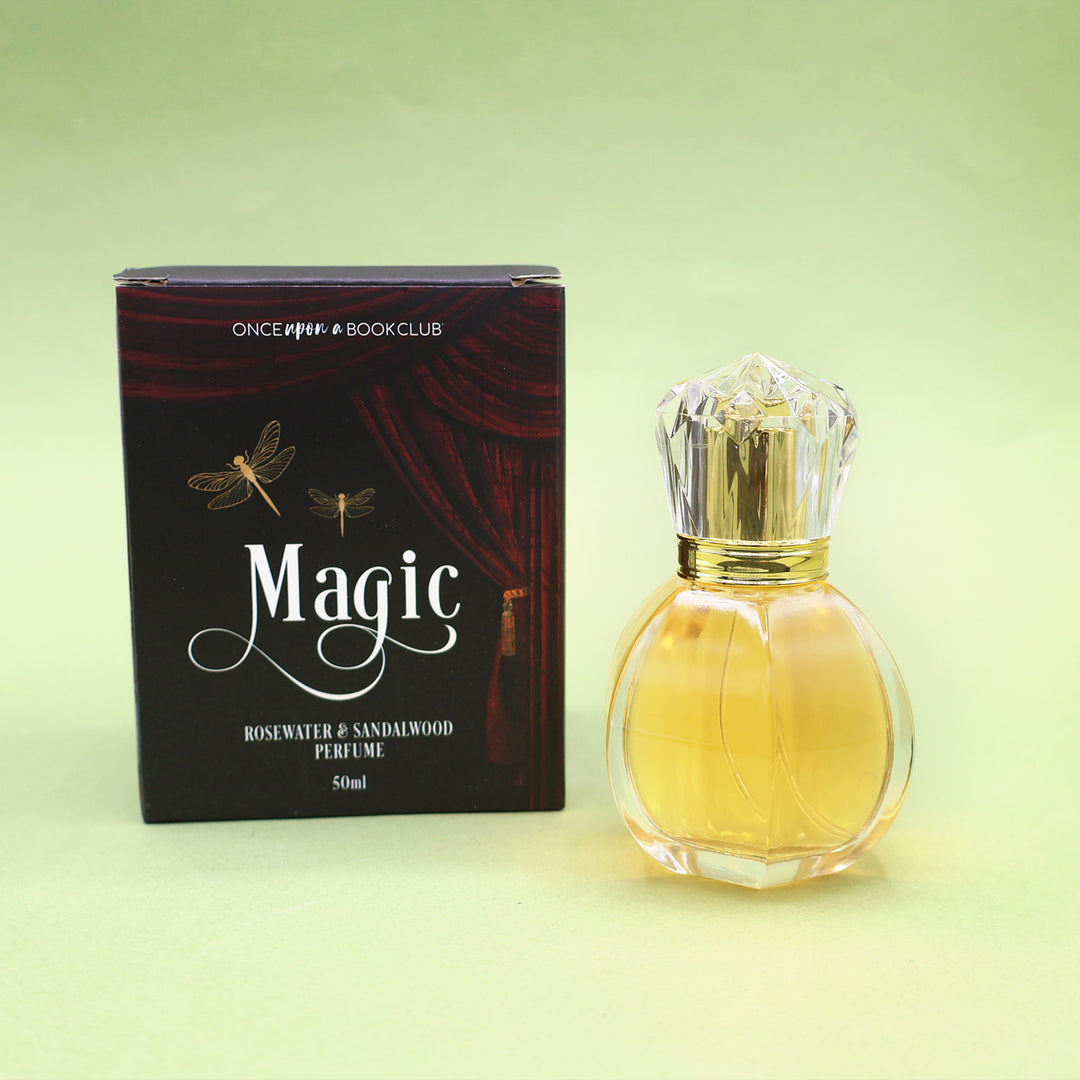 A box labeled Magic Rosewater & Sandalwood Perfume 50ml next to a clear bottle of perfume.