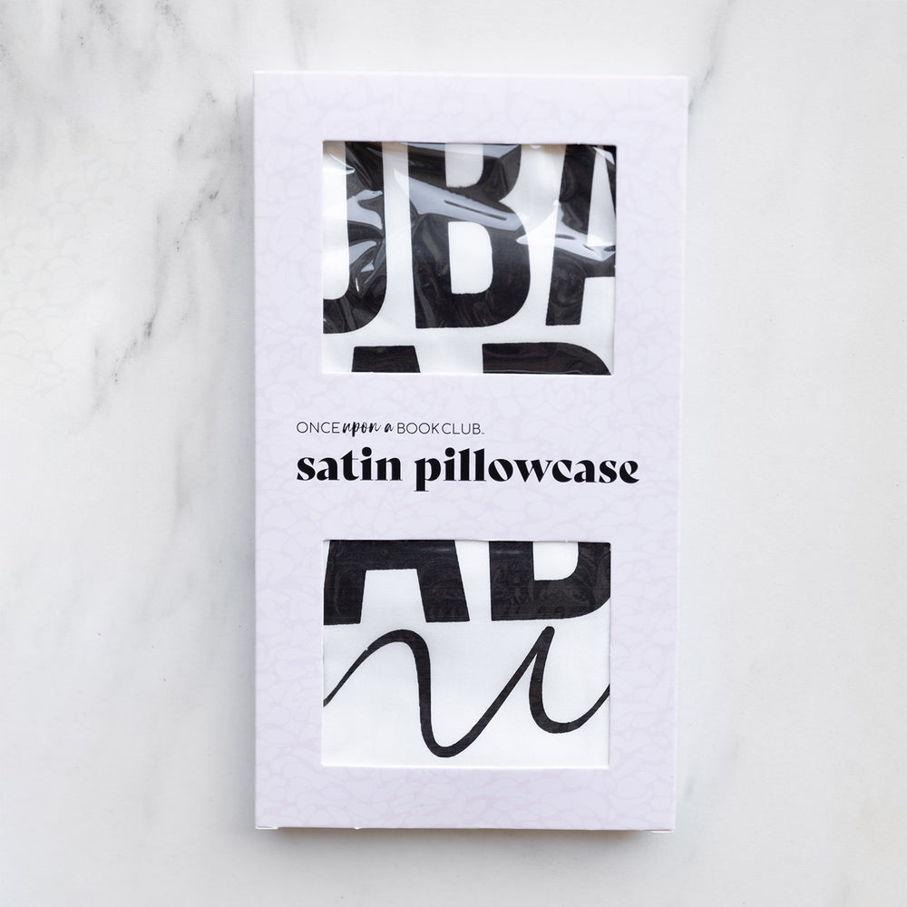 A satin pillowcase in a white window packaging.