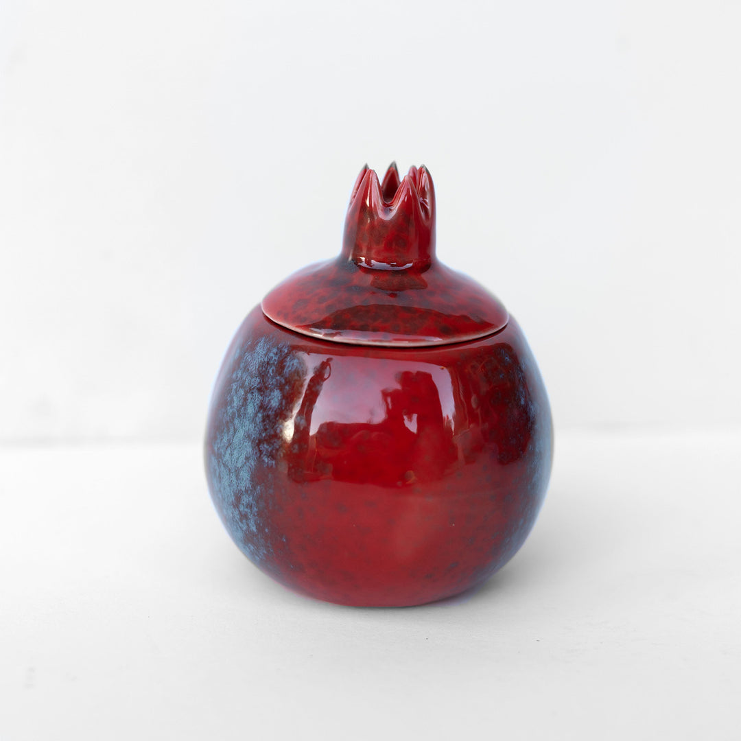 a pomegranate shaped ceramic candle