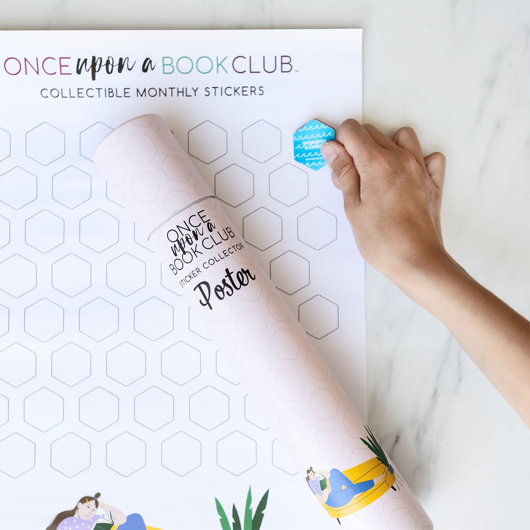 A white hand places a collectible sticker into one of the empty hexagon outlines on the monthly sticker poster. The poster tube (showcasing the same design as the poster in light pink) sits on top of the poster.