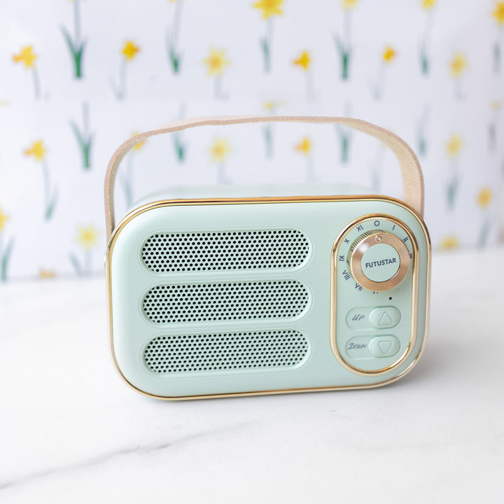 a miniature mint green bluetooth radio