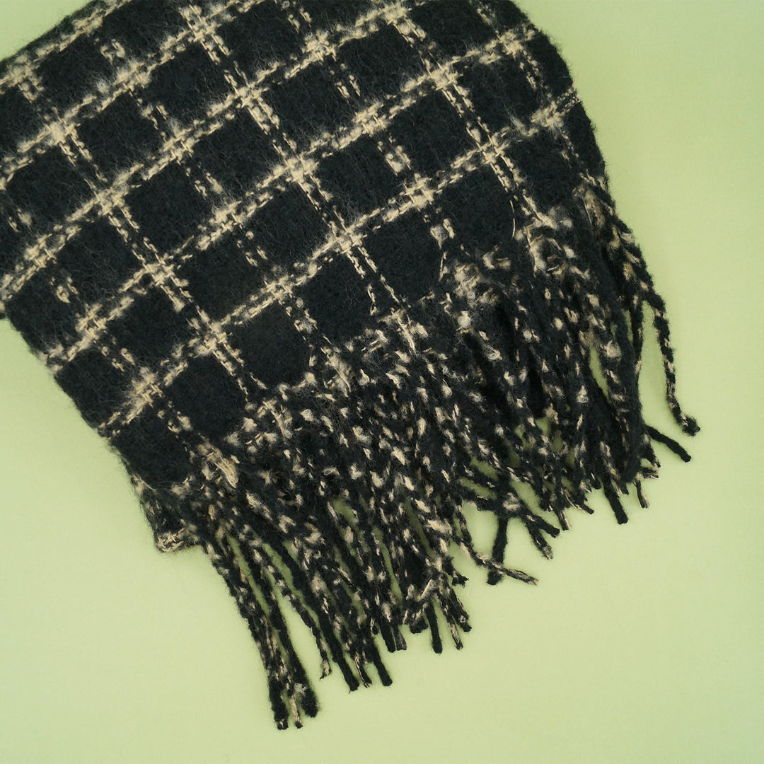 a black and taupe, checked-pattern, plush winter scarf.