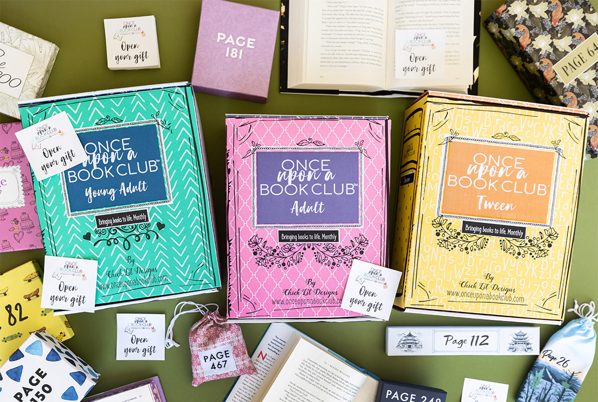 A green, pink, and yellow Once Upon a Book Club box sits on an army green background surrounded by wrapped gifts labeled with page numbers, open books, and sticky notes that read 