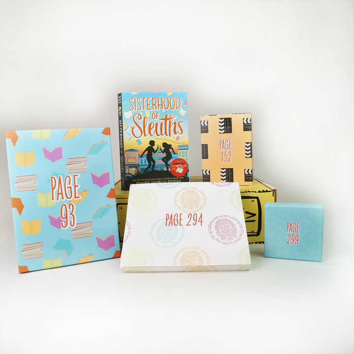 A paperback copy of Sisterhood of Sleuths by Jennifer Chambliss Bertman surrounded by wrapped gifts labeled with page numbers.