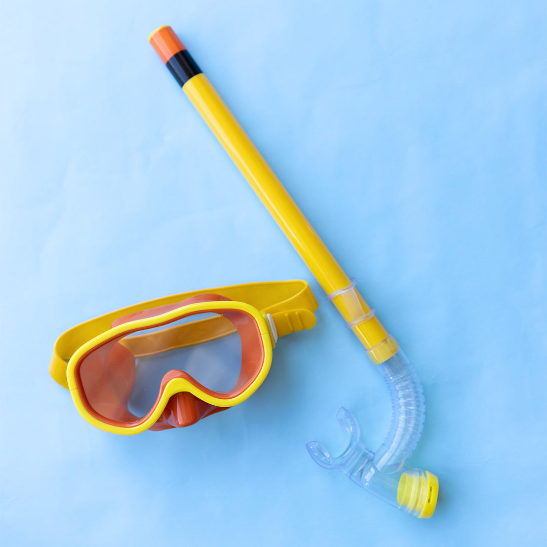 a bright yellow snorkel and diving goggles on a blue background.