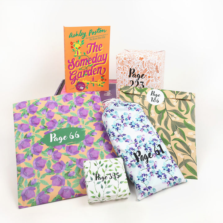A paperback edition of The Someday Garden by Ashley Poston stands on a pink OUABC box next to a wrapped gift labeled Page 223. In front of the box are four more floral themed, wrapped gifts labeled with page numbers.