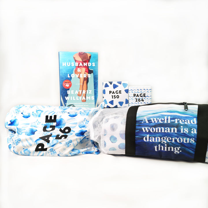 A hardcover copy of Husbands & Lovers by Beatriz Williams, three blue and white wrapped gifts labeled with page numbers (Page 56, Page 150, Page 264), and a custom designed tote bag featuring a blue polkadot pattern on a white background and the front pocket in a wave pattern printed with the words "A well-read woman is a dangerous thing".