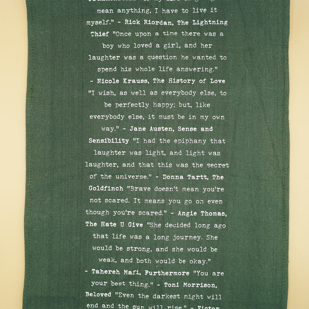 dark green table runner with quotes from books in white writing down the center