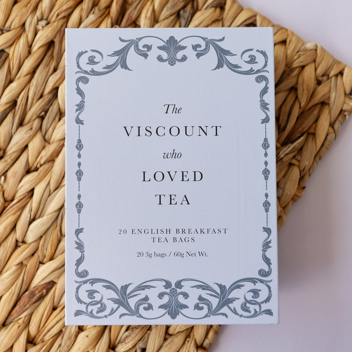 A light purple box with filigree surrounding the words in the middle - The Viscount Who Loved Tea - 20 English Breakfast Tea Bags.
