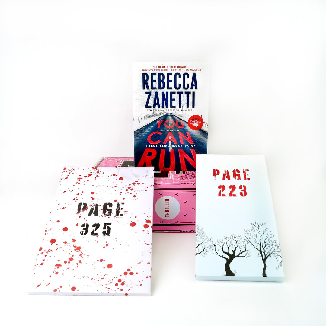 A mass market paperback edition of You Can Run by Rebecca Zanetti sits on a pink book box surrounded by two wrapped gifts labeled with page numbers.