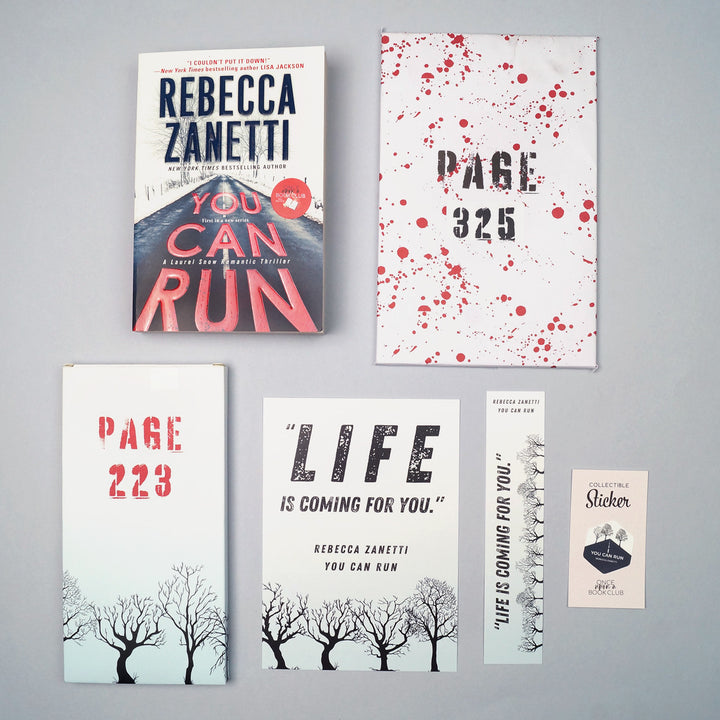 A mass market paperback edition of You Can Run by Rebecca Zanetti sits on a gray background surrounded by two wrapped gifts labeled with page numbers, a 5x7 art print, bookmark, and collectible sticker that matches the book.