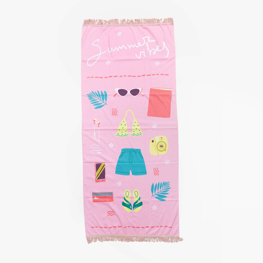 A light pink towel that says Summer Vibes in white lettering with multiple summer icons along the towel: leaves, sunglasses, swimsuit top, flip-flops, camera, book, headphones.