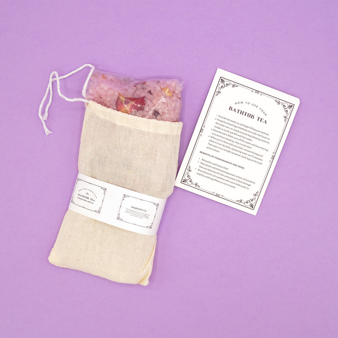 a woven bag contain an array of bath salts and flowers, along with instructions of how to use your bath tea.