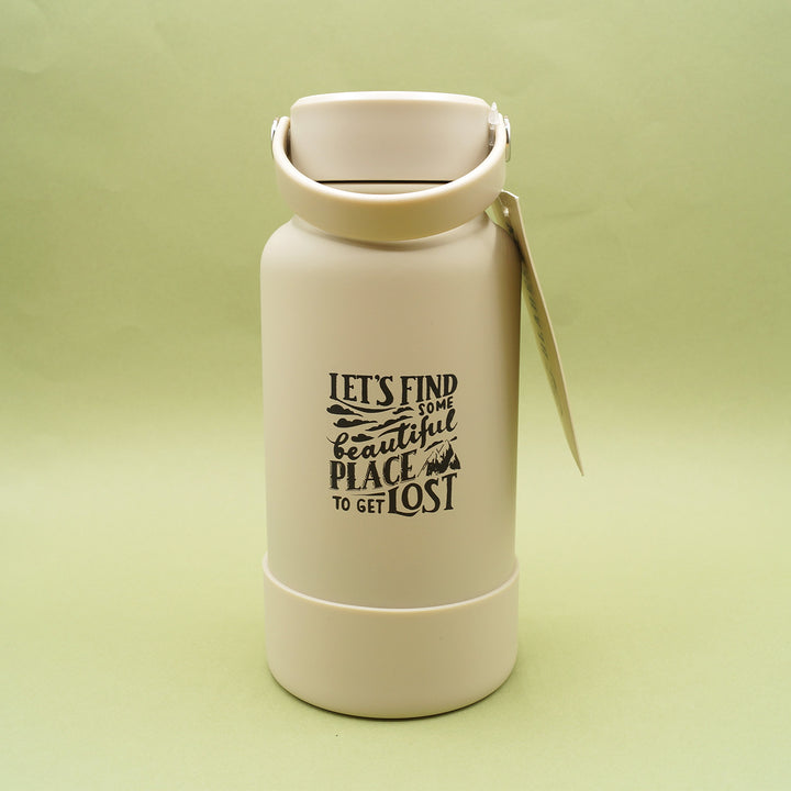 A light taupe colored water bottle with handle lid sits on a green background.