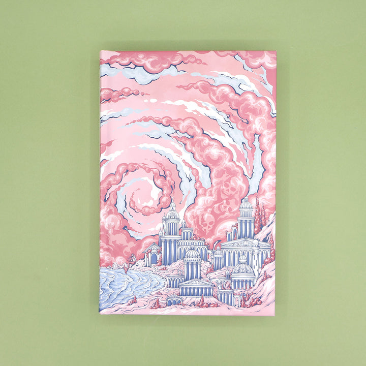 A closed copy of 'The Wicked Sea' without the dust jacket featuring artwork of a cityscape with pink clouds on a green background