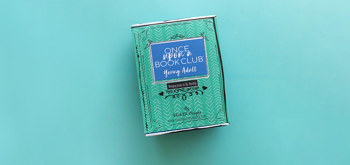 A green Once Upon a Book Club Young Adult box sits on a teal green background.